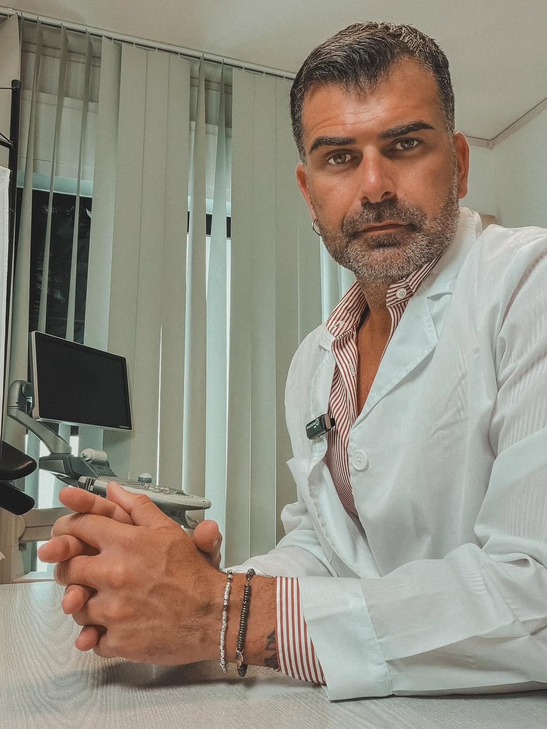 Mirko Boni seated in a light shirt, looking toward camera.
